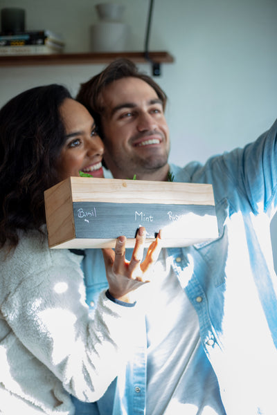 55 Cheap Date Ideas That Are Fun And Create Connection. Couple posing for a selfie with the planter that they built together.