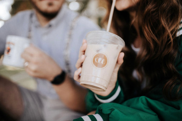 55 Cheap Date Ideas That Are Fun And Create Connection. Close-up shot of couple enjoying iced coffee together.