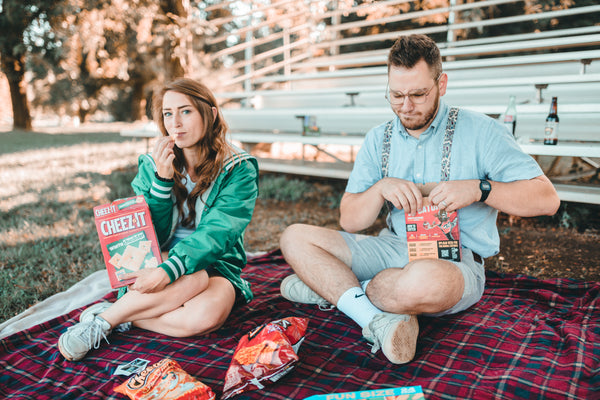 7 Ways to Rekindle Your Relationship's Spark: Couple enjoying a picnic together while eating chips at the park