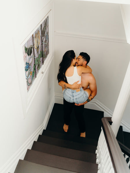 7 Ways to Rekindle Your Relationship's Spark: Guy carrying the girl up the stairs