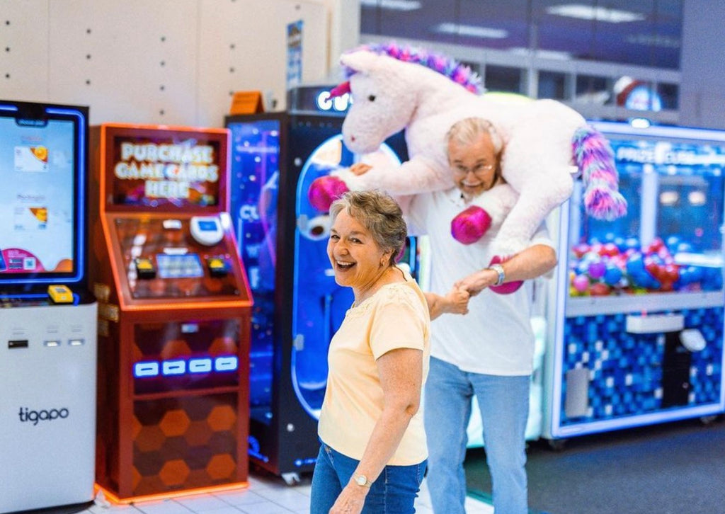Reignite the spark in your relationship with weekly date nights. Elderly couple having a date night at the arcade.