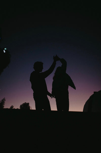 Creative, Romantic, and Fun Stay-at-Home Date Ideas for Couples: Silhouette of couple as they dance at night