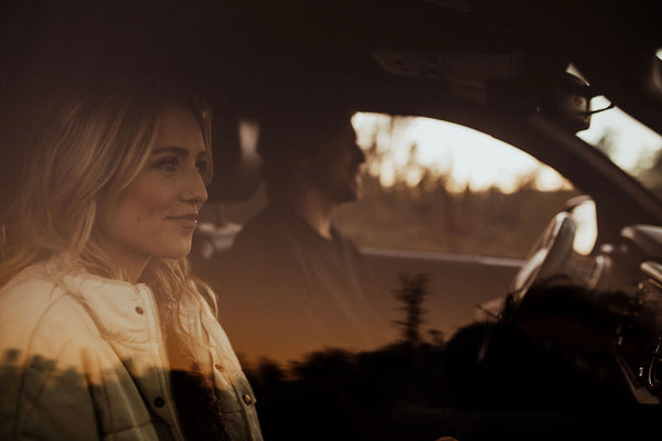 Creative, Romantic, and Fun Stay-at-Home Date Ideas for Couples: Couple smiling inside the car