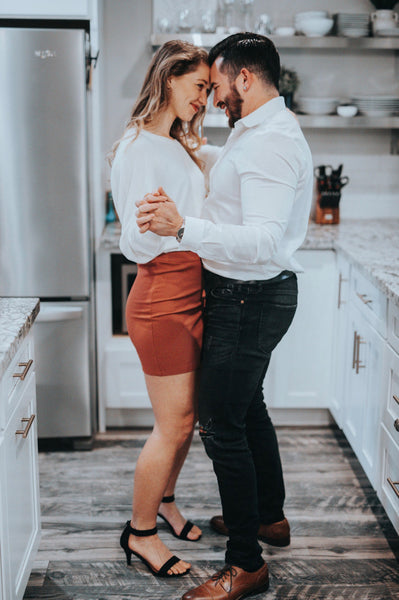 A couple dance together in a modern kitchen