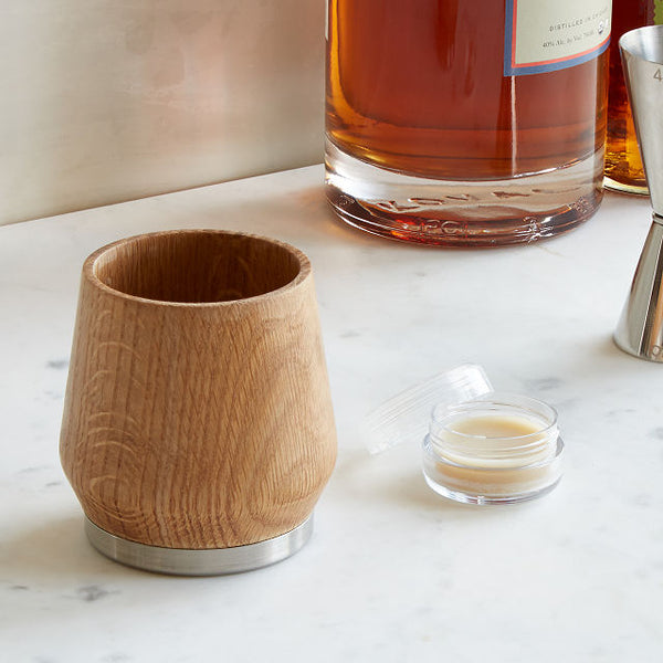 Whiskey Enhancing Tumbler with honey wax beside it
