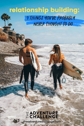 Surfer couple treading along the beach with their surfboards; image overlaid with text that reads relationship building: 7 things you've probably never thought to do