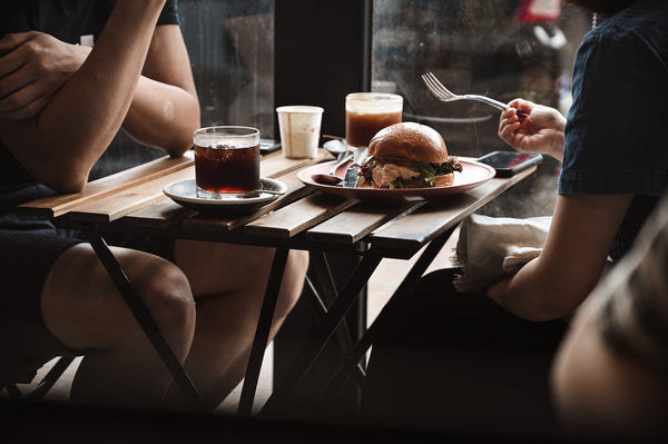 Couple at a restaurant trying out new food and starting new traditions to strengthen their relationship