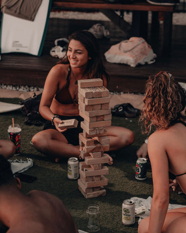 An image of two friends playing jenga together