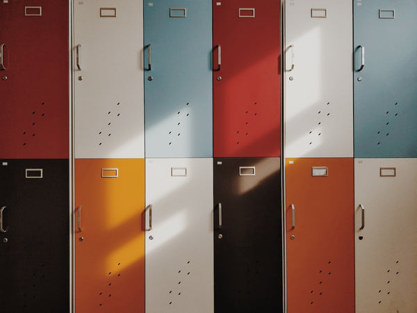 The Ultimate Back to School List for 2021. Two rows of colorful lockers.