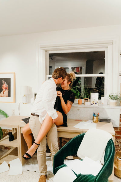 Why You Should Have a Sexual Bucket List: Couple sharing an embrace in an office.