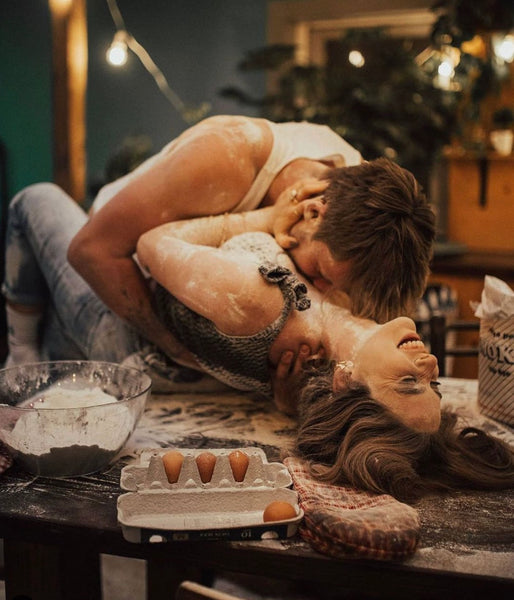 Why You Should Have a Sexual Bucket List: Couple getting intimate in the kitchen with flour all over them.