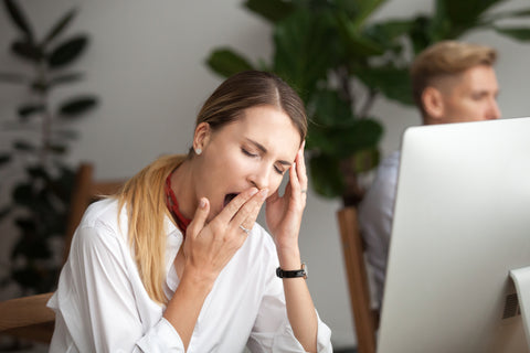 Woman experiencing fatigue at her desk