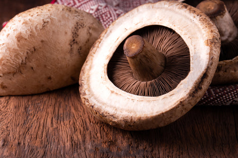 portobello mushrooms over old wood background