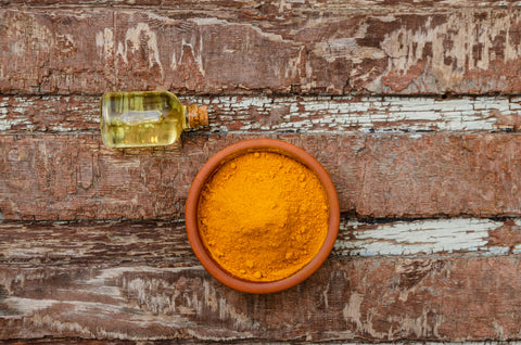 turmeric and turmeric oil on wood