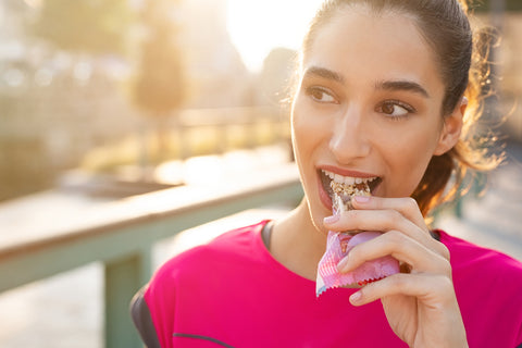 Woman enjoying a snack bar on a workout