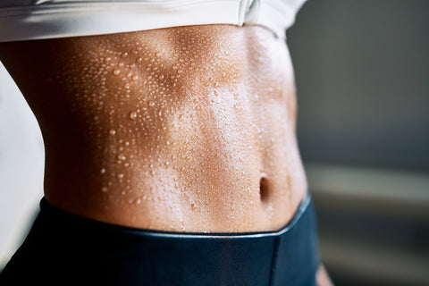 Woman sweating from abdomen