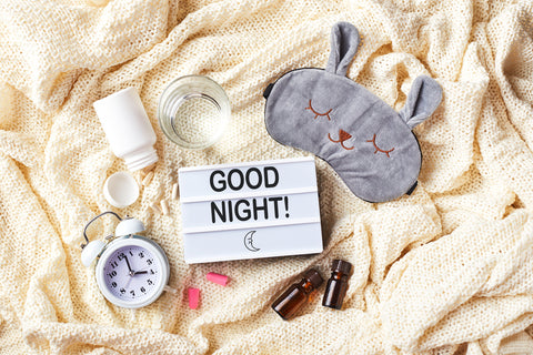 Sleeping mask, alarm clock, earplugs, essential oils and pills. Healthy night sleep creative concept. Flat lay, top view. Good night, sleep hygiene, insomnia