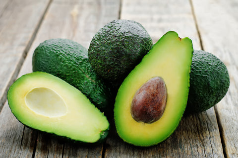 avocado on a dark wood background. tinting. selective focus