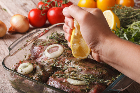 Man marinating meat in dish