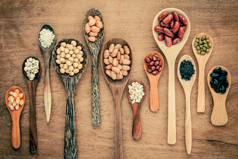 Assortment of beans and lentils in wooden spoon on teak wood background. mung bean, groundnut, soybean, red kidney bean , black bean ,sesame, corn ,red bean and brown pinto beans