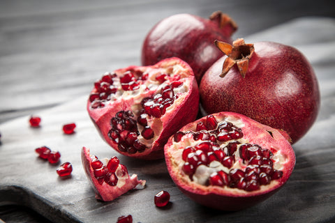 Red juicy pomegranate on dark background