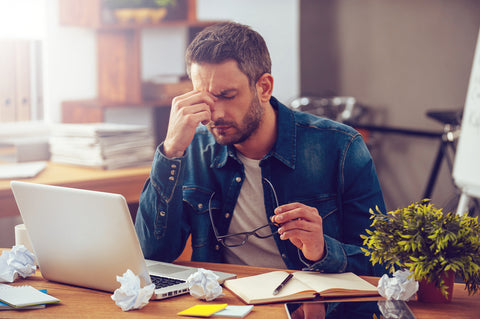 Man showing stress while working at desk