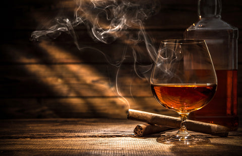 Cigar and whiskey on wood