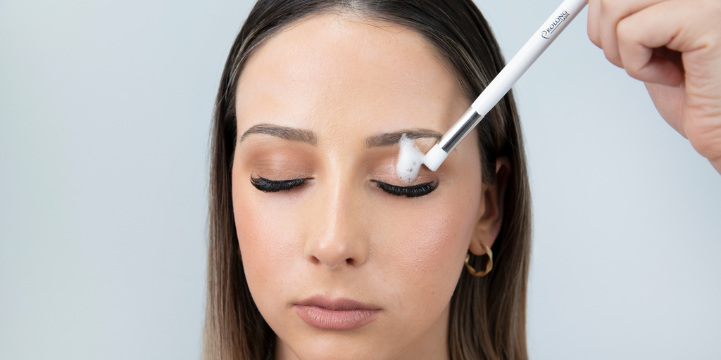 Woman cleaning lash extensions with Prolong Lash Cleanser 