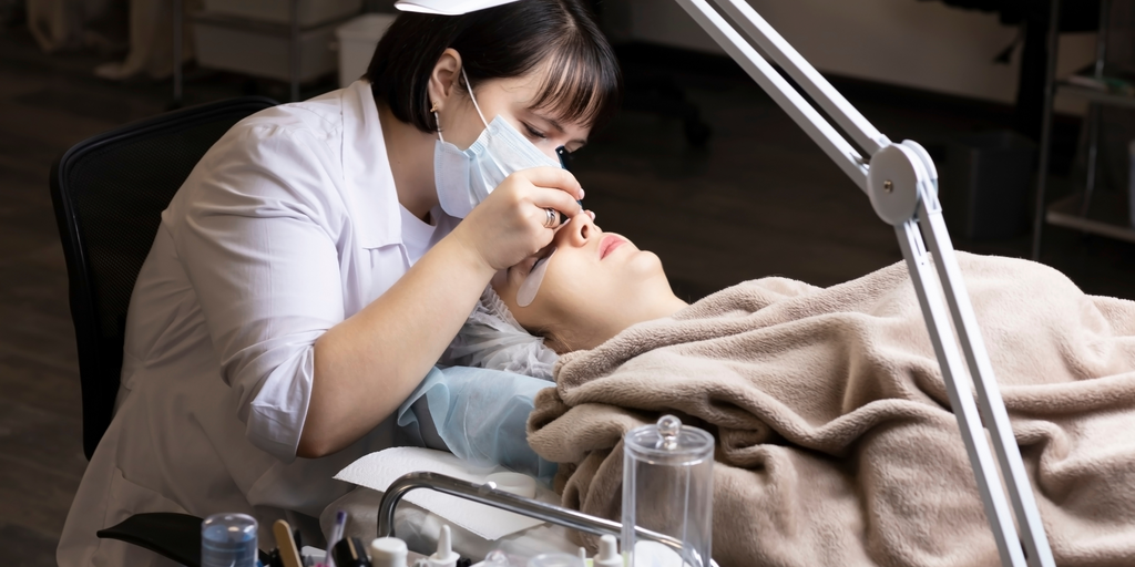 Woman having her eyelash extensions done I Prolong Lash