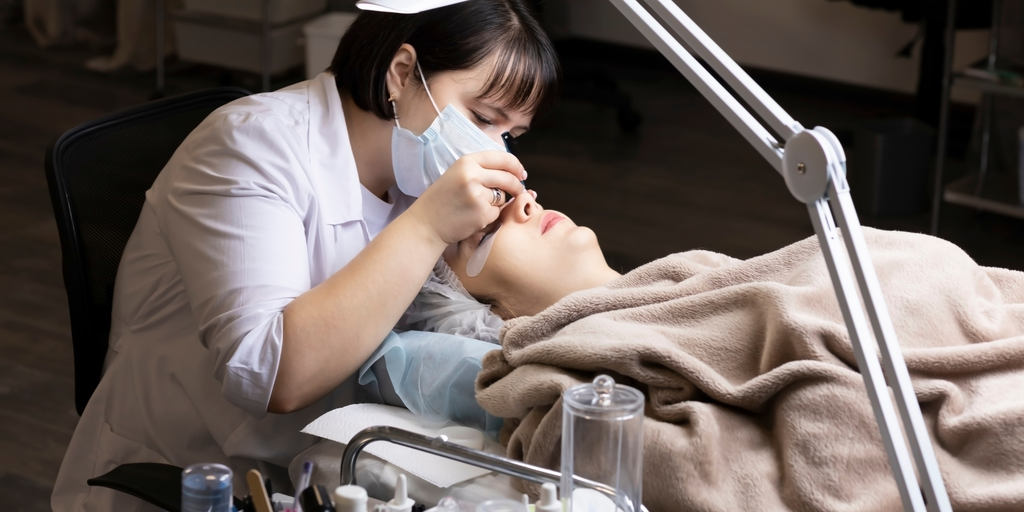 Woman having her eyelash extensions done I Prolong Lash 