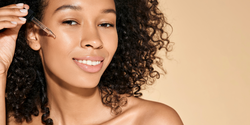 Woman applying eye serum