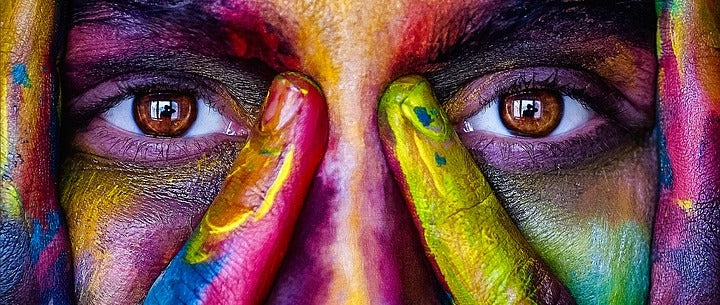 image of a woman with color powder on her face and hands