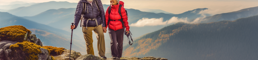 elderly couple climbs mountain, representing good health and wellness