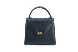 Front view Ostrich leather constructed top flap handbag with an Italian turn-lock closure. Inside zipper pocket, leather suede interior. Top handle 24 carat gold plated hardware,detachable shoulder strap with adjustable buckle. Bottom feet studs.