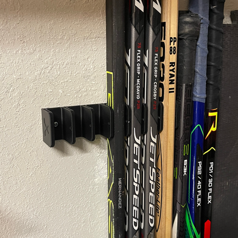 Keep your hockey sticks organized with this 10-stick hockey stick holder, mounted in the garage. 