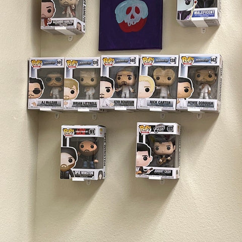 Using command strips to mount Funko floating shelves on the wall - low-cost wall mount for Funko boxes