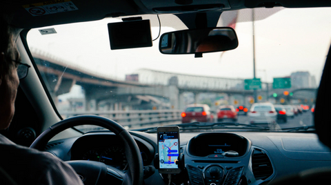 driving through traffic with a phone mount on the dashboard