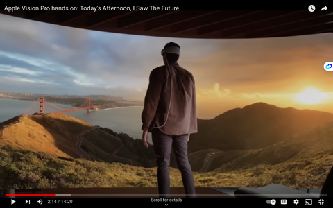 a man stand in frong a huge tv screen inside apple pro vision 