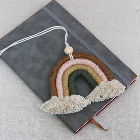 Handmade macrame rainbow on a grey faux leather journal