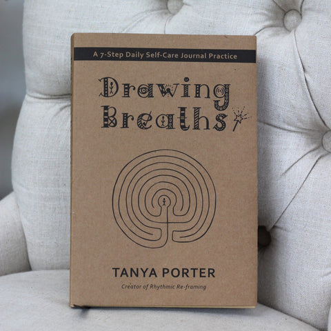 Drawing Breaths, by Tanya Porter, displayed on a beige chair