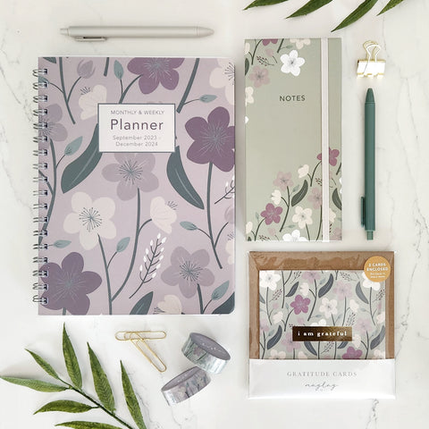 2024 Planner Agenda, sticky notes folio, gratitude card and other stationery on a white table top