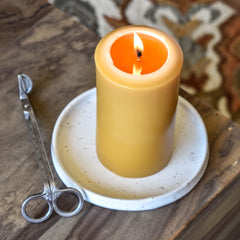 Beeswax Pillar candle burning with wax pool