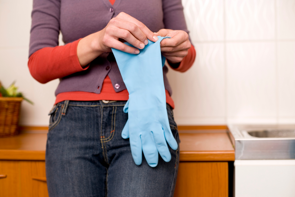 woman putting on rubber gloves