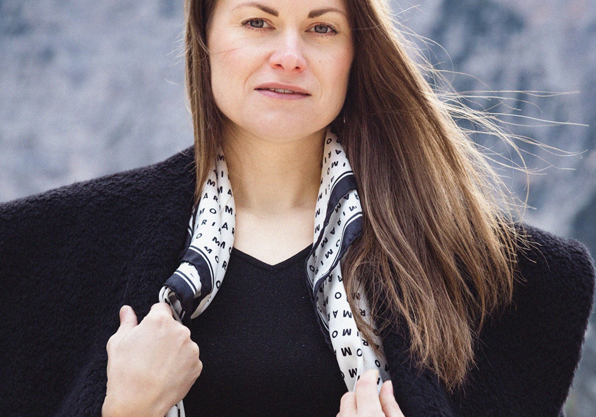 Woman wearing a silk scarf and alpaca coat