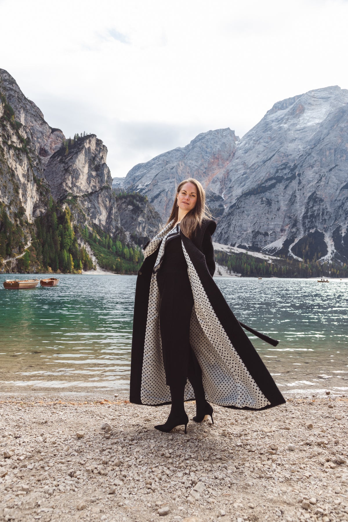 Woman in black coat in Italian Alps