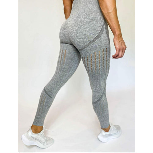 Premium Photo | A big woman booty in leggings on grey background.