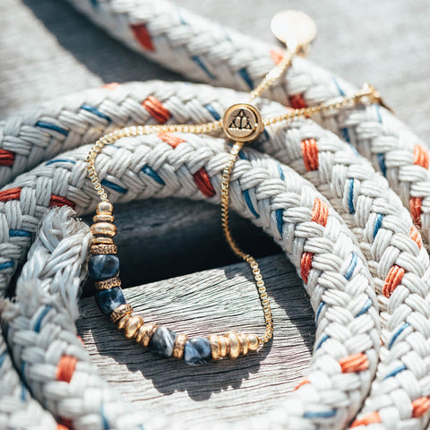 Air and Anchor's Blue Sodalite Bracelet in Gold resting on rope.