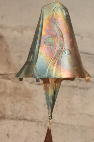 Bronze windbell with swirling design and rainbow-like surface finish