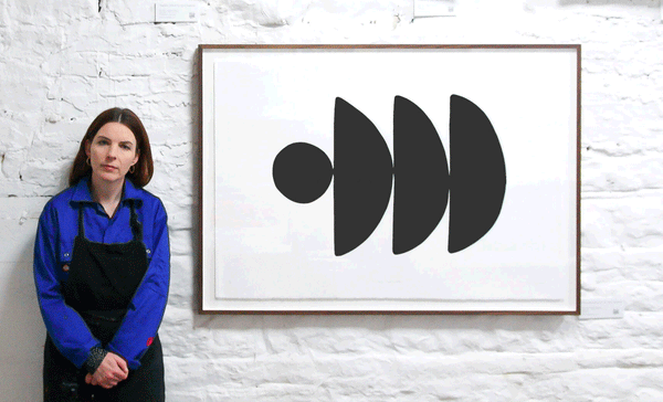 alice fitzgerald standing beside one of her prints