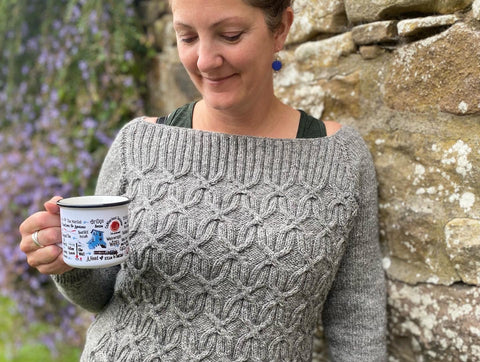 Kate wearing a Widow's Kiss jumper with a cup of tea